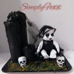 Creepy baby faux candle display
